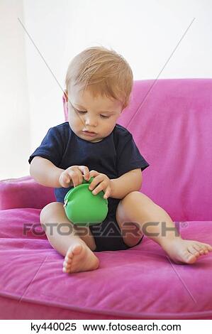 Baby boy playing with a pouch bag View Large Photo Image Stock Photography - Baby boy playing with a pouch bag. Fotosearch
