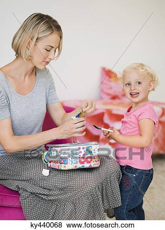 Woman opening compote container for her daughter View Large Photo Image Stock Photo - Woman opening compote container for her daughter. Fotosearch