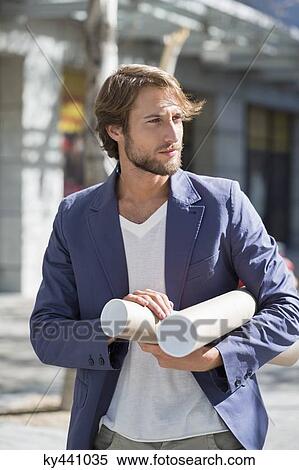 Architect carrying paper rolls View Large Photo Image Stock Photography - Architect carrying paper rolls. Fotosearch