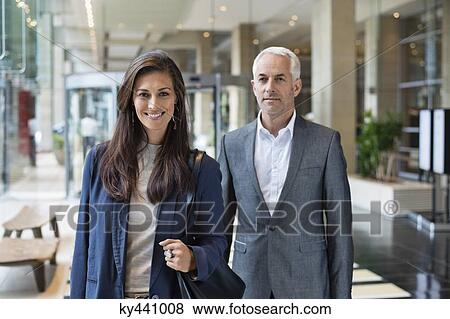 Business couple standing in a hotel lobby View Large Photo Image Stock Photo - Business couple standing in a hotel lobby. Fotosearch