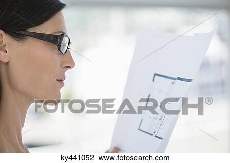 Close-up of a woman reading a document View Large Photo Image Stock Image - Close-up of a woman reading a document. Fotosearch