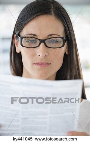 Close-up of a woman reading a document View Large Photo Image Stock Photography - Close-up of a woman reading a document. Fotosearch