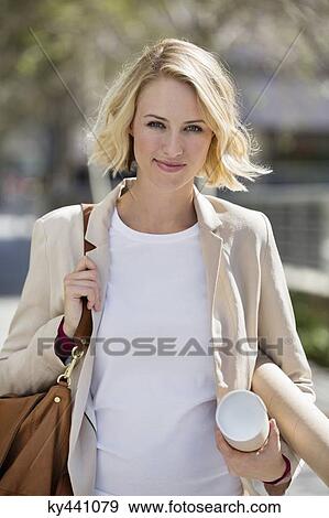 Portrait of a female architect carrying paper rolls View Large Photo Image Stock Photo - Portrait of a female architect carrying paper rolls. Fotosearch