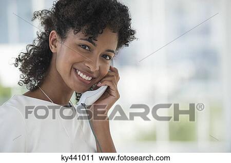 Portrait of a woman talking on a landline phone View Large Photo Image Stock Image - Portrait of a woman talking on a landline phone. Fotosearch