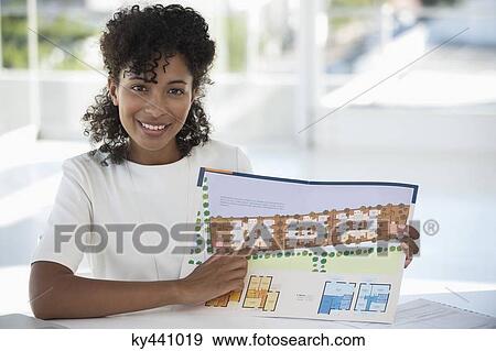 Real estate agent showing a plan View Large Photo Image Stock Photo - Real estate agent showing a plan. Fotosearch