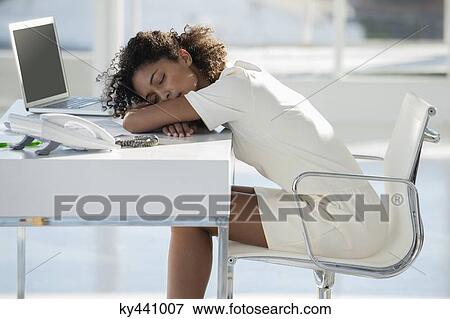Woman napping with her head resting on desk View Large Photo Image Stock Photo - Woman napping with her head resting on desk. Fotosearch