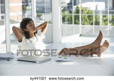 Woman relaxing on a chair at home View Large Photo Image Stock Image - Woman relaxing on a chair at home. Fotosearch