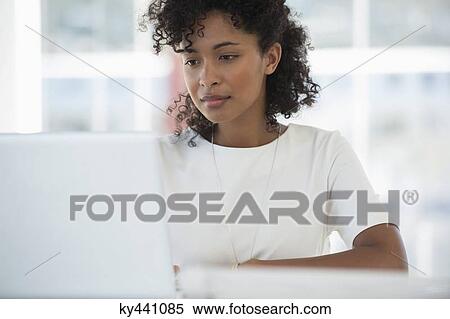 Woman working on a laptop at home View Large Photo Image Stock Photography - Woman working on a laptop at home. Fotosearch