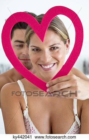 Couple with a heart shape object View Large Photo Image Stock Image - Couple with a heart shape object. Fotosearch
