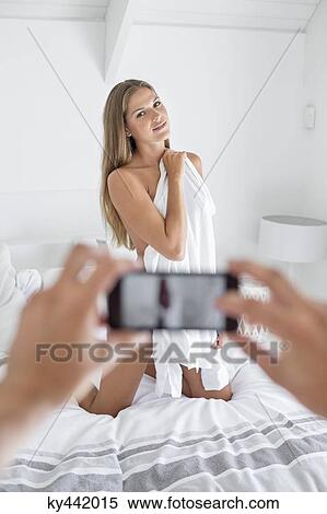 Man taking picture of his girlfriend in the bedroom View Large Photo Image Stock Photography - Man taking picture of his girlfriend in the bedroom. Fotosearch