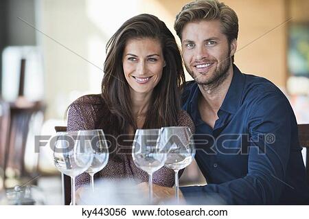 Couple enjoying drinks in a restaurant View Large Photo Image Stock Photograph - Couple enjoying drinks in a restaurant. Fotosearch