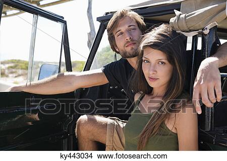 Couple in a SUV View Large Photo Image Picture - Couple in a SUV. Fotosearch