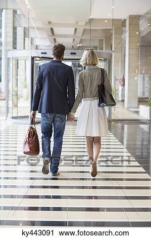 Couple walking at an airport View Large Photo Image Stock Image - Couple walking at an airport. Fotosearch