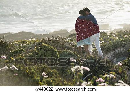 Stock Image - Couple walking on the beach. Fotosearch