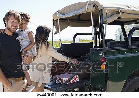 Happy family beside a SUV View Large Photo Image Stock Image - Happy family beside a SUV. Fotosearch