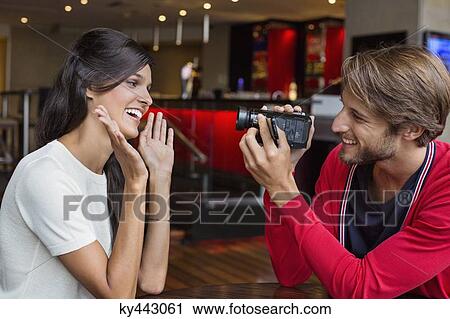 Man filming his girlfriend with a home video camera View Large Photo Image Stock Image - Man filming his girlfriend with a home video camera. Fotosearch