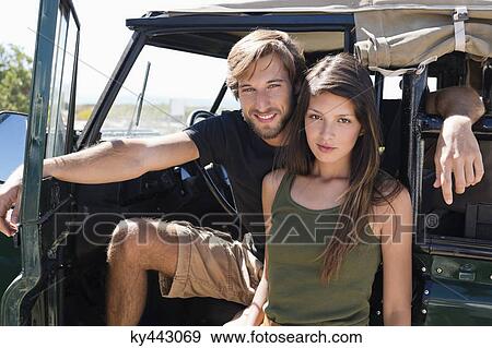 Portrait of a couple on SUV View Large Photo Image Stock Photo - Portrait of a couple on SUV. Fotosearch