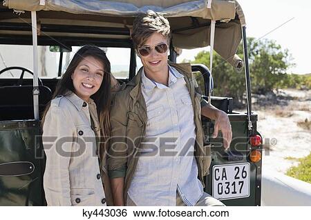 Portrait of a couple smiling beside a SUV View Large Photo Image Stock Photograph - Portrait of a couple smiling beside a SUV. Fotosearch