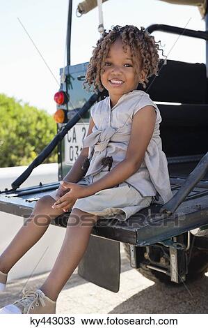 Portrait of a girl sitting in a SUV and smiling View Large Photo Image Stock Image - Portrait of a girl sitting in a SUV and smiling. Fotosearch