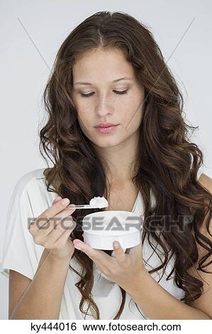 Close-up of a woman holding a container of moisturizer cream View Large Photo Image Stock Photograph - Close-up of a woman holding a container of moisturizer cream. Fotosearch