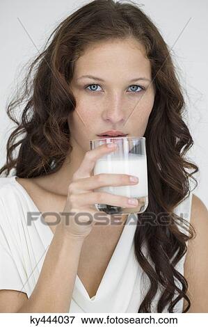 Stock Photo - Portrait of a woman drinking milk. Fotosearch