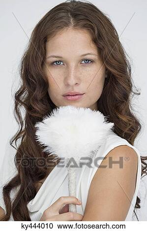 Portrait of a woman holding a feather duster View Large Photo Image Stock Image - Portrait of a woman holding a feather duster. Fotosearch