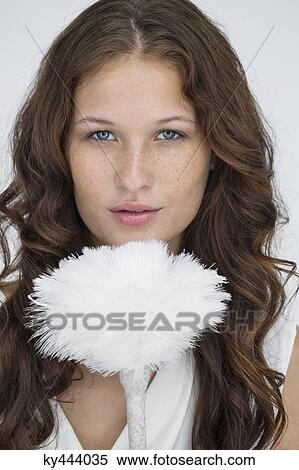 Portrait of a woman holding a feather duster View Large Photo Image Stock Photography - Portrait of a woman holding a feather duster. Fotosearch
