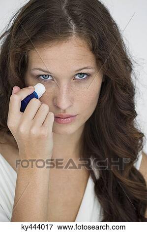 Woman applying anti wrinkle cream on her face View Large Photo Image Stock Photo - Woman applying anti wrinkle cream on her face. Fotosearch