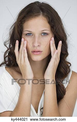 Woman checking wrinkles on her face View Large Photo Image Stock Image - Woman checking wrinkles on her face. Fotosearch