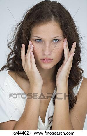Stock Photo - Woman checking wrinkles on her face. Fotosearch