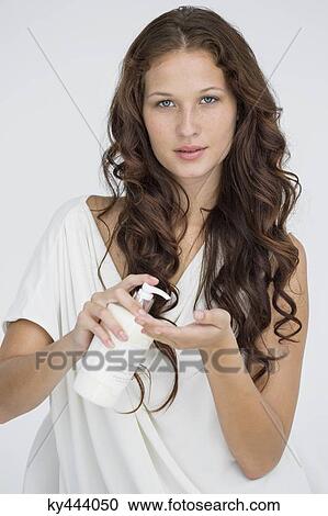 Woman pouring moisturizer on hand View Large Photo Image Stock Image - Woman pouring moisturizer on hand. Fotosearch