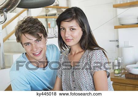 Portrait of a couple smiling in the kitchen View Large Photo Image Stock Photo - Portrait of a couple smiling in the kitchen. Fotosearch
