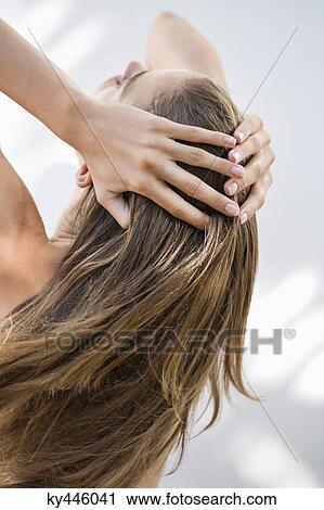Close-up of a woman holding her hair View Large Photo Image Stock Image - Close-up of a woman holding her hair. Fotosearch