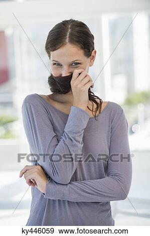 Portrait of a beautiful woman posing View Large Photo Image Stock Photo - Portrait of a beautiful woman posing. Fotosearch