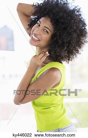 Portrait of a smiling woman posing View Large Photo Image Stock Image - Portrait of a smiling woman posing. Fotosearch