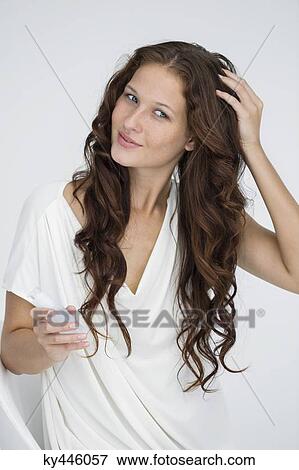 Woman applying conditioner in her hair View Large Photo Image Stock Photo - Woman applying conditioner in her hair. Fotosearch