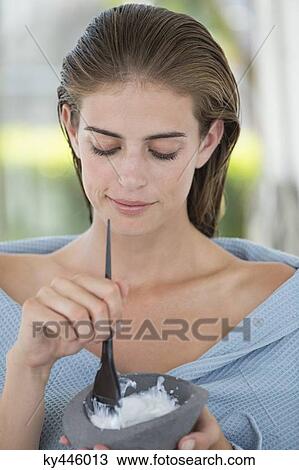 Woman mixing hair dye in a bowl View Large Photo Image Stock Image - Woman mixing hair dye in a bowl. Fotosearch