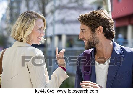 Stock Photography - Man and woman smiling at each other. Fotosearch