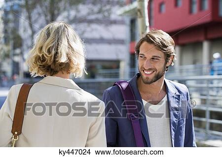 Man flirting a woman and smiling View Large Photo Image Picture - Man flirting a woman and smiling. Fotosearch