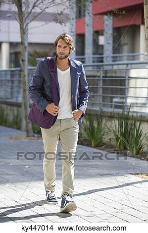 Picture - Man walking on a street. Fotosearch