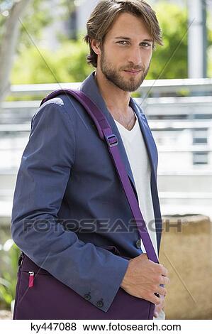 Stock Photo - Portrait of a man with a shoulder bag. Fotosearch