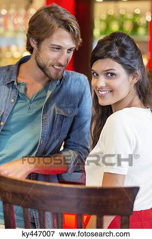 Smiling couple at a restaurant View Large Photo Image Stock Photo - Smiling couple at a restaurant. Fotosearch
