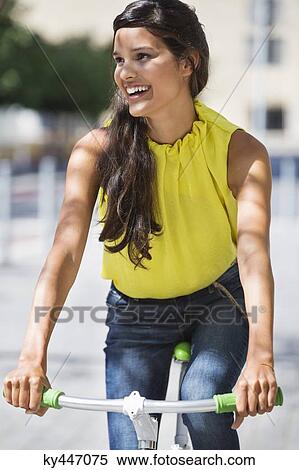 Woman riding a bicycle and smiling View Large Photo Image Stock Photography - Woman riding a bicycle and smiling. Fotosearch