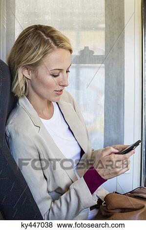 Woman using a mobile phone View Large Photo Image Stock Photo - Woman using a mobile phone. Fotosearch