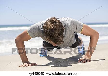 Man exercising on the beach View Large Photo Image Stock Image - Man exercising on the beach. Fotosearch