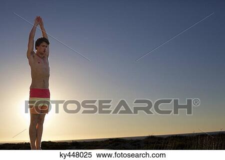 Stock Photography - Man standing with arms raised. Fotosearch