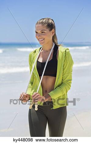 Portrait of a woman holding a skipping rope View Large Photo Image Stock Photo - Portrait of a woman holding a skipping rope. Fotosearch