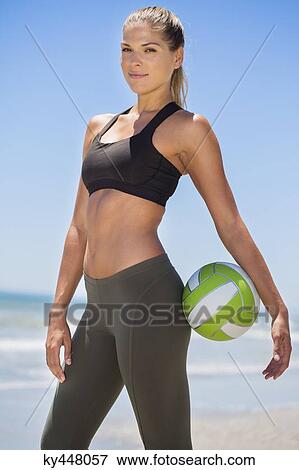 Portrait of a woman holding a volleyball View Large Photo Image Stock Photo - Portrait of a woman holding a volleyball. Fotosearch