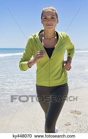 Portrait of a woman running on the beach View Large Photo Image Stock Image - Portrait of a woman running on the beach. Fotosearch