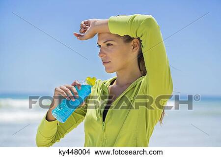 Picture - Woman drinking water from a bottle. Fotosearch